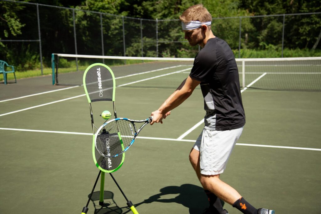A man about to hit a tennis ball on the court.